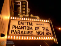 Digital colour photo of the "Now playing" sign at the Paradise Theatre. The sign is lit up against the dark sky. The sign reads "DMTTM: Presents Phantom of the Paradise Nov 24"